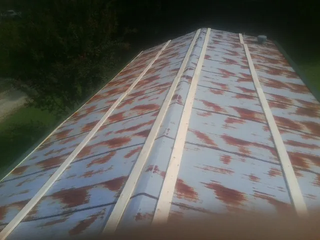 Rusted metal roof panels with new wood purlins before replacement — Storm Damage Roof Repair in Richmondville by Roofing Brothers